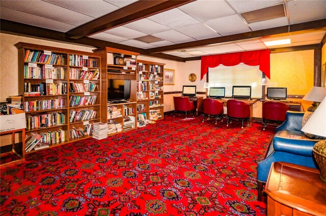 sitting room featuring carpet and a drop ceiling