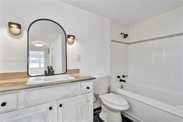 full bathroom with vanity, toilet, and tiled shower / bath combo