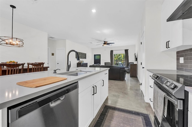 kitchen featuring hanging light fixtures, sink, decorative backsplash, appliances with stainless steel finishes, and white cabinetry