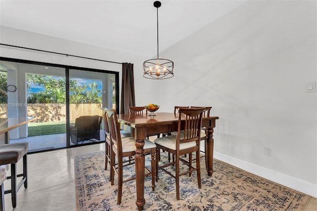 dining room featuring vaulted ceiling and an inviting chandelier