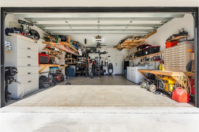 garage featuring independent washer and dryer and a workshop area