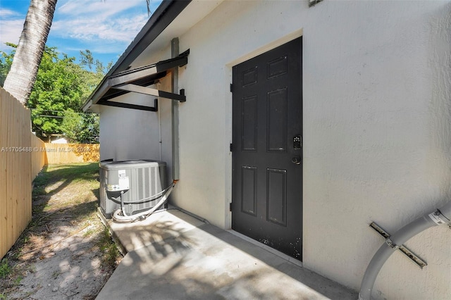 property entrance featuring central AC unit