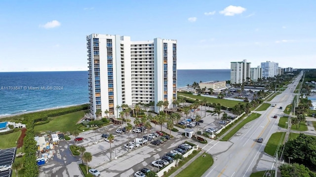 drone / aerial view with a water view and a beach view