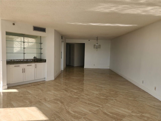 interior space with sink and a textured ceiling