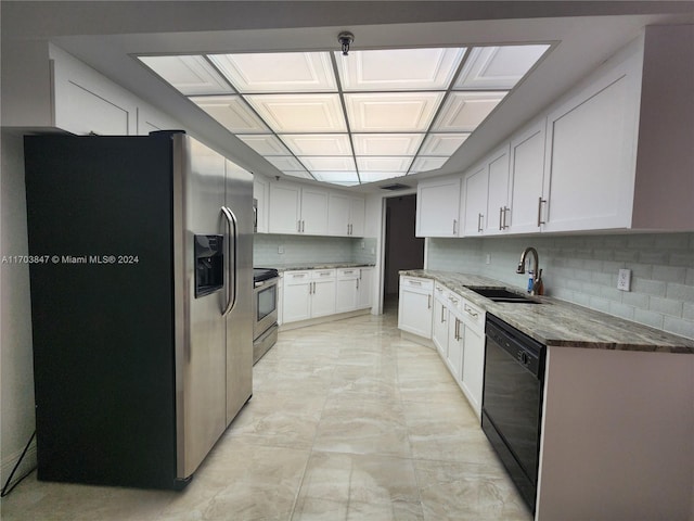 kitchen featuring stone counters, white cabinetry, sink, stainless steel appliances, and tasteful backsplash