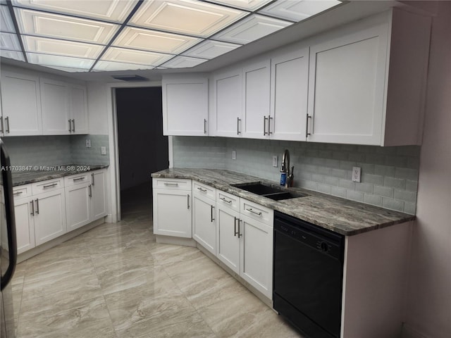 kitchen with white cabinetry, sink, black dishwasher, backsplash, and dark stone countertops