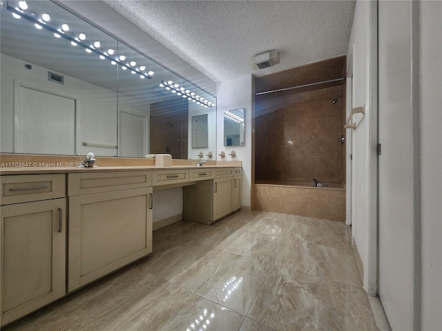 bathroom with vanity, a textured ceiling, and bathing tub / shower combination