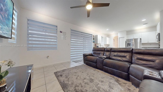 living room with ceiling fan and light tile patterned flooring