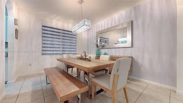 dining space with light tile patterned floors and a chandelier