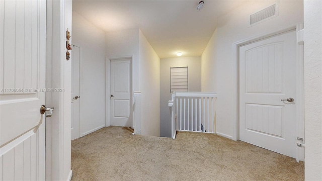 corridor with light colored carpet