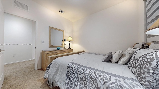 bedroom featuring light carpet and vaulted ceiling