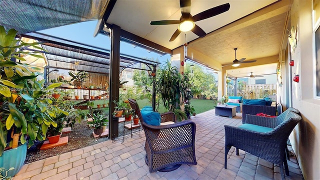 view of patio featuring an outdoor living space and ceiling fan