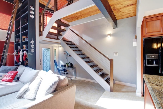 interior space with tile patterned flooring and beamed ceiling