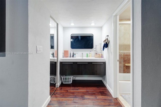 bathroom featuring hardwood / wood-style floors, vanity, and separate shower and tub