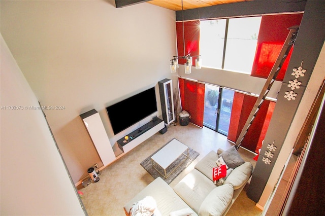 living room with french doors, a towering ceiling, and a wealth of natural light