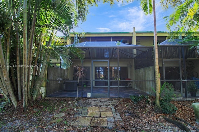 rear view of house with a patio area, a lanai, and central air condition unit