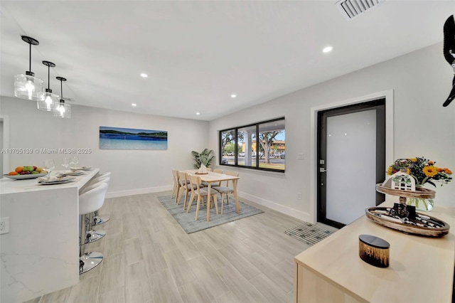 dining space featuring light wood-type flooring