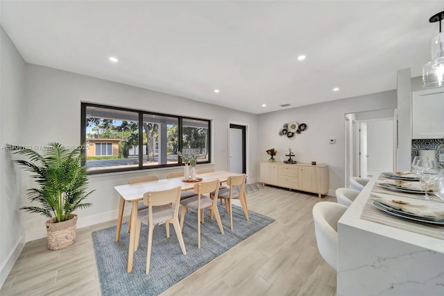 dining space with light hardwood / wood-style floors