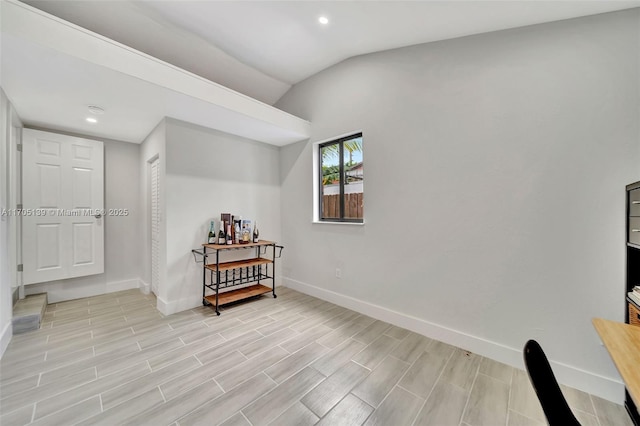 sitting room featuring vaulted ceiling