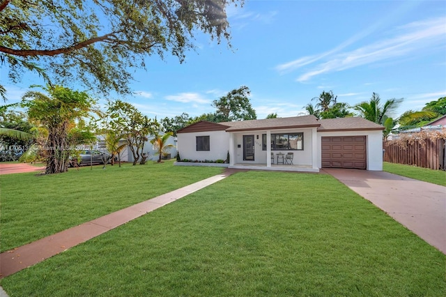 ranch-style home featuring a garage and a front yard