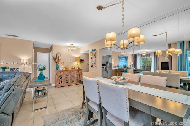 tiled dining area featuring a chandelier