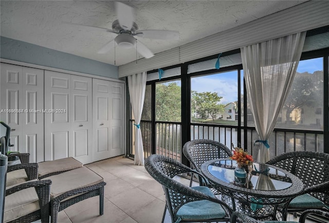 sunroom / solarium featuring ceiling fan