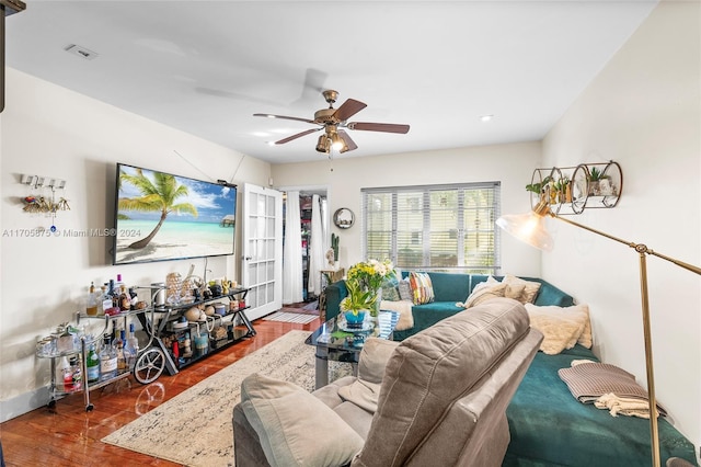 living room featuring dark hardwood / wood-style floors and ceiling fan