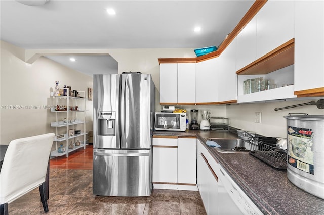 kitchen featuring dark hardwood / wood-style flooring, white cabinetry, sink, and white appliances