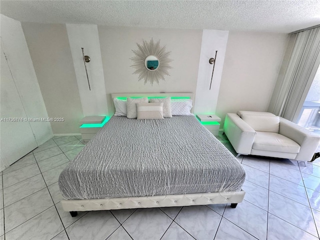 bedroom with tile patterned floors and a textured ceiling