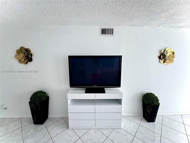 dining space with light tile patterned floors and a textured ceiling