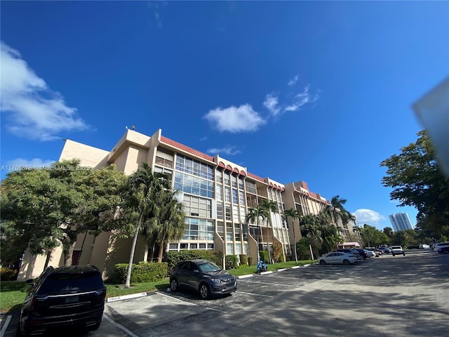 view of building exterior featuring uncovered parking