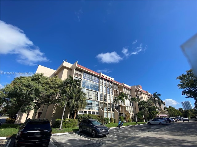 view of building exterior featuring uncovered parking