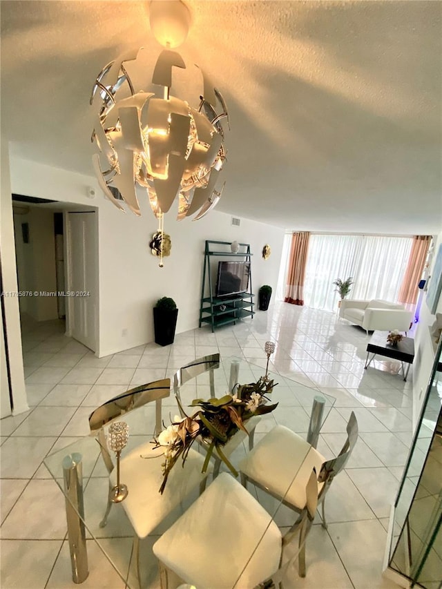 dining space featuring tile patterned flooring and a textured ceiling