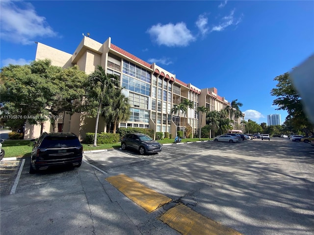 view of property featuring uncovered parking