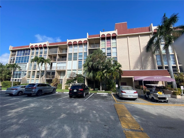 view of building exterior featuring uncovered parking