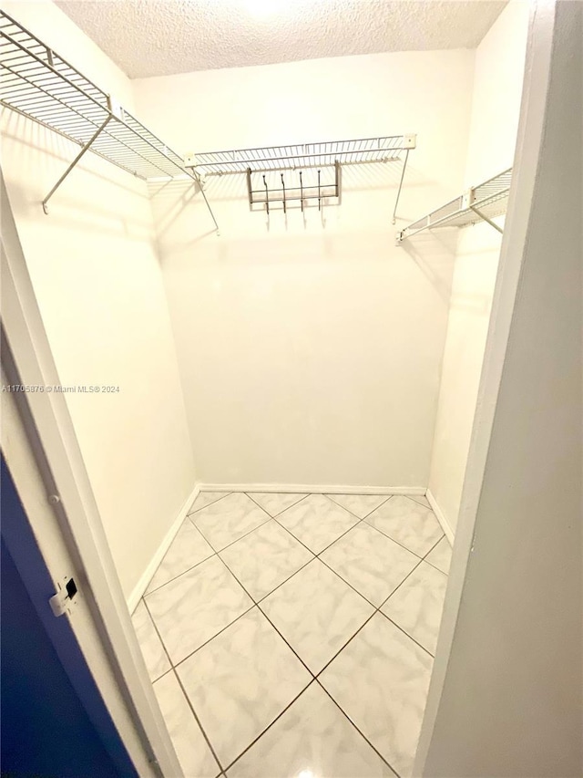 spacious closet featuring tile patterned flooring