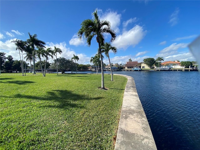 surrounding community with a yard and a water view