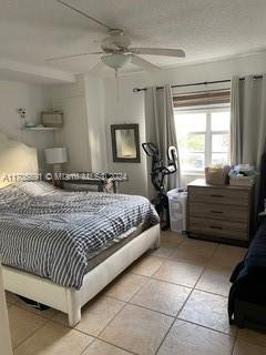 bedroom featuring ceiling fan and light tile patterned flooring