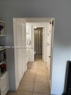 hallway featuring light tile patterned flooring