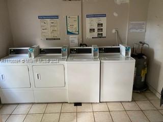 washroom with washer and dryer and light tile patterned flooring