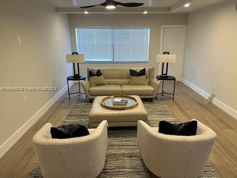 living room featuring ceiling fan and wood-type flooring