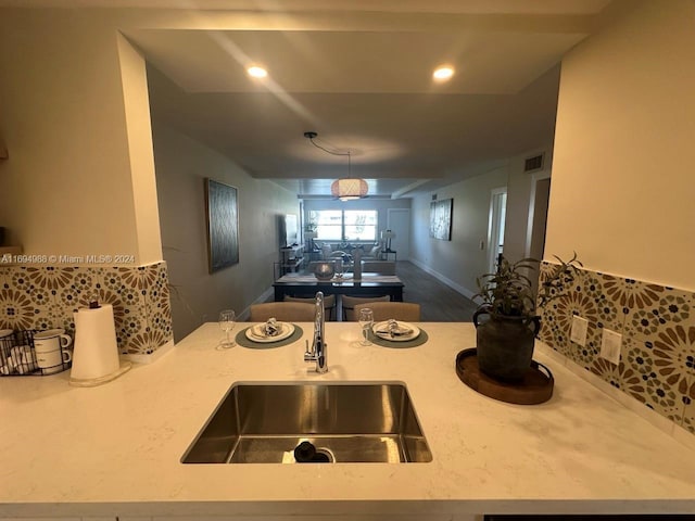 kitchen featuring sink and an inviting chandelier