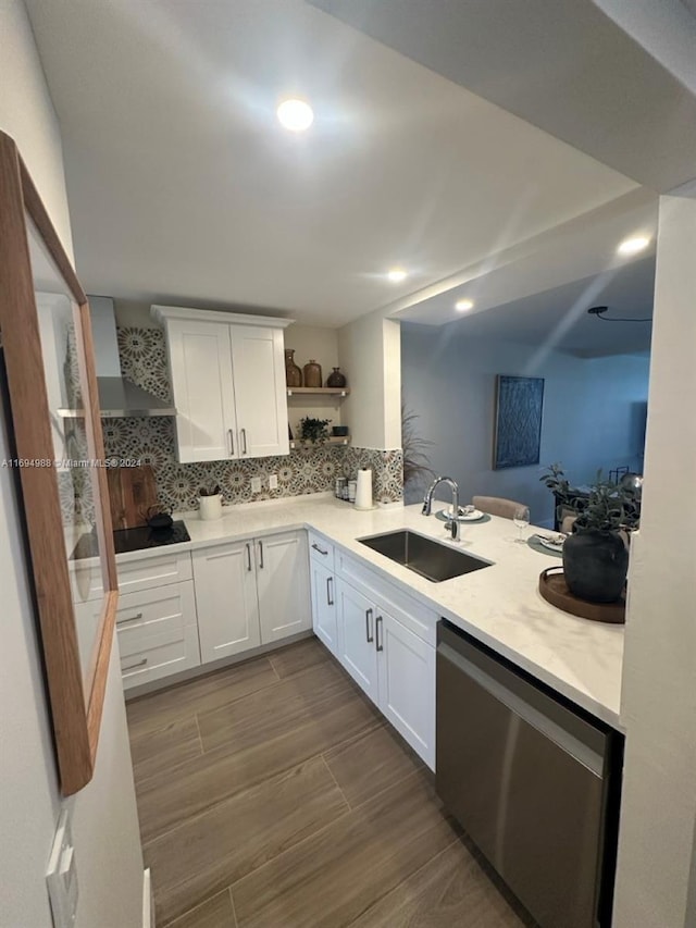 kitchen featuring white cabinets, tasteful backsplash, wall chimney exhaust hood, sink, and dishwasher