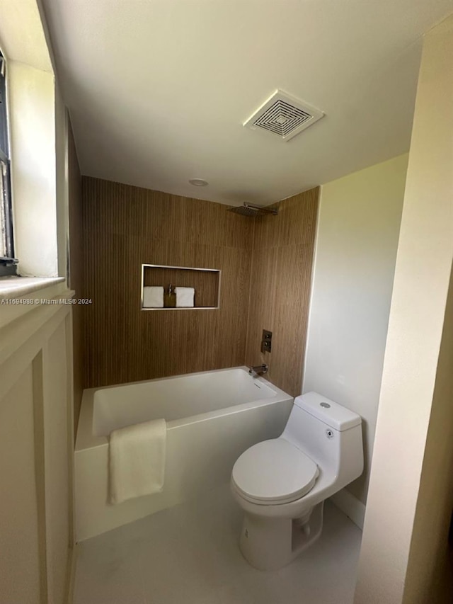 bathroom with shower / bathing tub combination, wood walls, and toilet