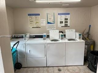 washroom featuring washing machine and dryer and light tile patterned floors