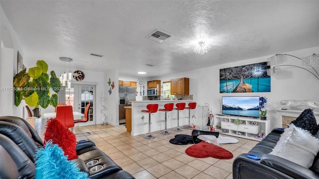 living room with light tile patterned flooring and a textured ceiling