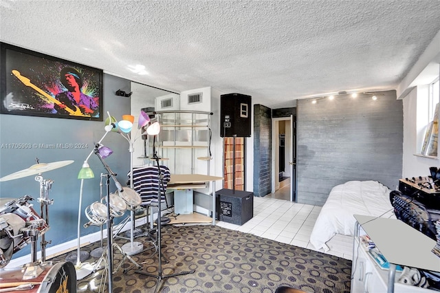 bedroom featuring light tile patterned floors and a textured ceiling