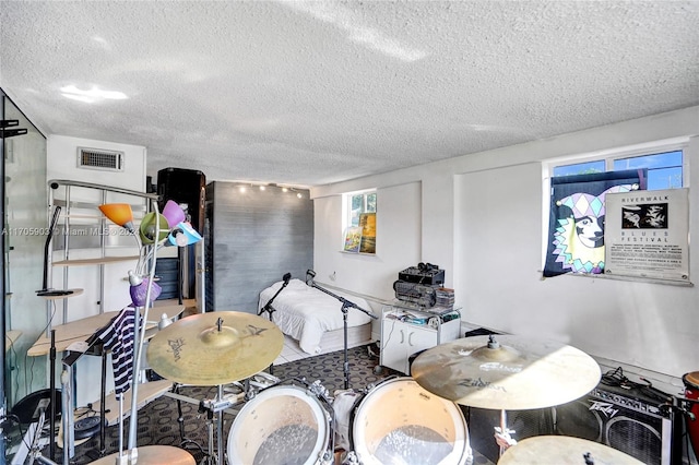 interior space with tile patterned flooring and a textured ceiling