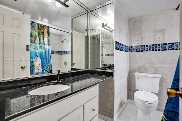 bathroom with walk in shower, tile patterned floors, toilet, vanity, and tile walls