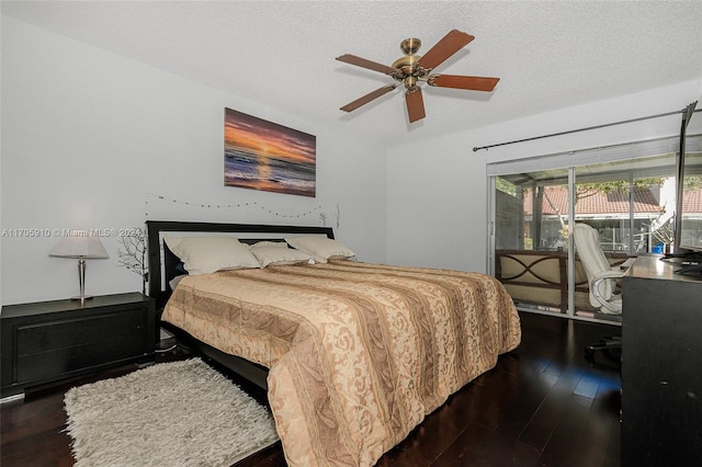 bedroom featuring access to exterior, ceiling fan, dark wood-type flooring, and a textured ceiling